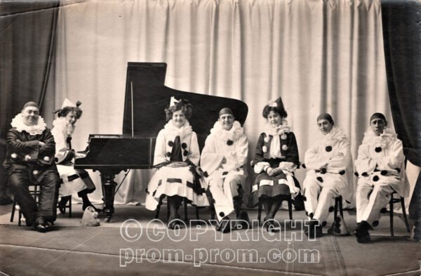 The_Follies_-_HG_Pelissier_sitting_on_the_left_in_dark_costume