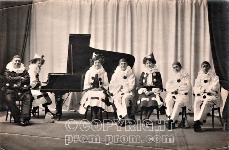 The_Follies_-_HG_Pelissier_sitting_on_the_left_in_dark_costume